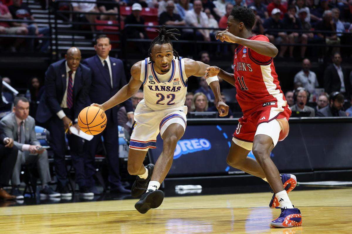 Darryn Peterson #22 of the Kansas Jayhawks drives to the basket defended by Ian Jackson #11 of the St. John's Red Storm during the first half in the second round of the 2026 NCAA Tournament at Viejas Arena on March 22, 2026 in San Diego.
