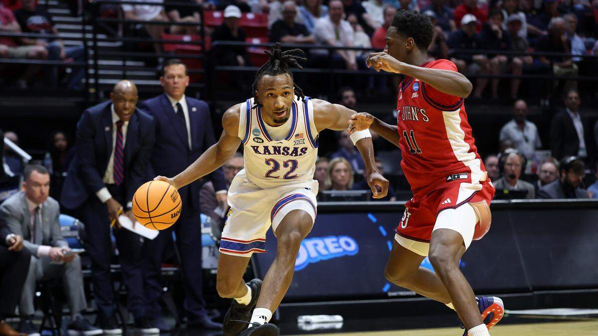 Darryn Peterson #22 of the Kansas Jayhawks drives to the basket defended by Ian Jackson #11 of the St. John's Red Storm during the first half in the second round of the 2026 NCAA Tournament at Viejas Arena on March 22, 2026 in San Diego.
