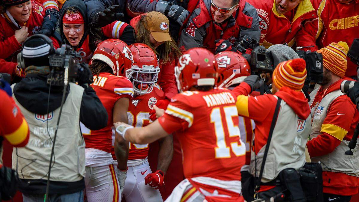 Kansas City Chiefs running back Damien Williams (No. 26, in the crowd) was mobbed by fans and teammates after running for an 84-yard touchdown against the L.A. Chargers Sunday at Arrowhead Stadium.