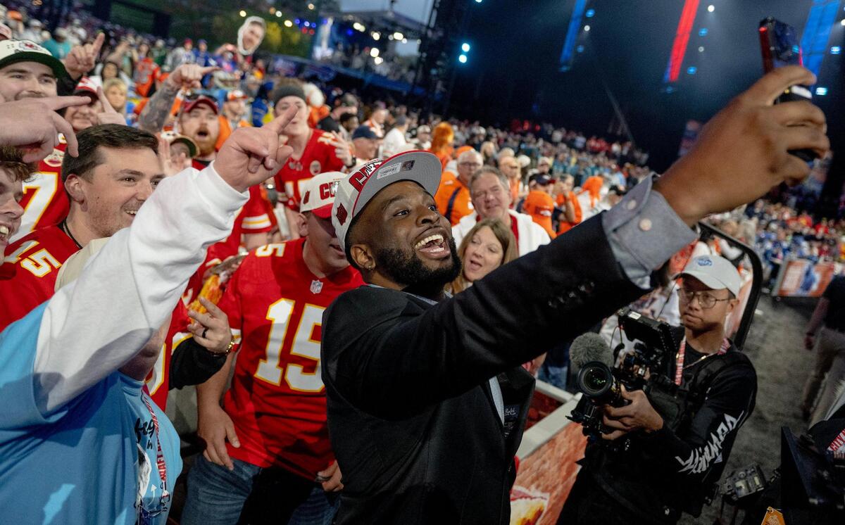 Kansas State defensive end Felix Anudike-Uzomah takes pictures with Chiefs fans during the second round of the NFL Draft outside of Union Station on Friday, April 28, 2023, in Kansas City. Anudike-Uzomah was selected 31st overall by the Kansas City Chiefs.