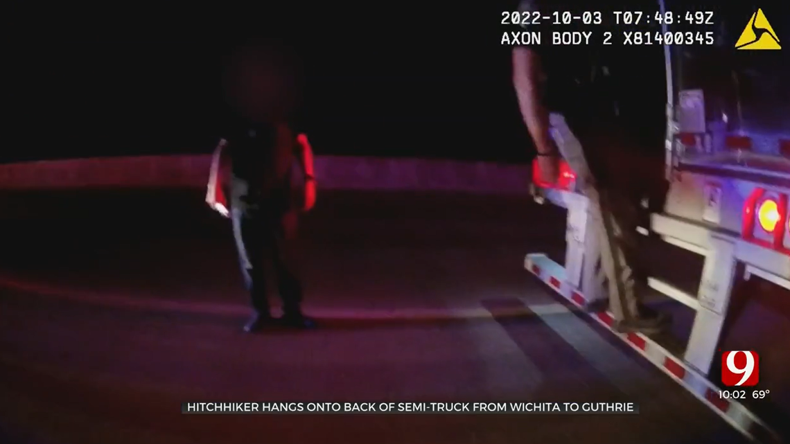 An Oklahoma trooper hangs on to the back of a semi-truck, trying to figure out how a man did so for 130 miles, according to body camera video obtained by KOTV.