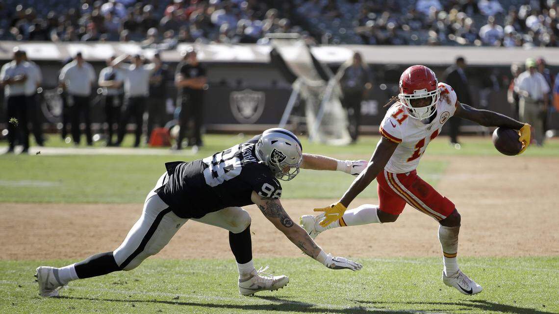 Chiefs wide receiver Demarcus Robinson, who had two touchdown receptions Sunday, eludes Oakland Raiders defensive end Maxx Crosby.