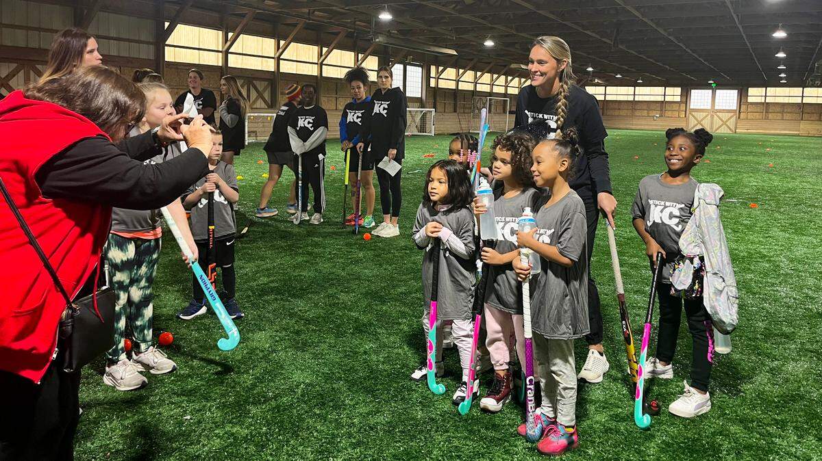 Kylie Kelce poses for photos at a youth field hockey clinic she hosted Sunday with Stick With KC ahead of the Chiefs-Eagles Super Bowl rematch Monday.