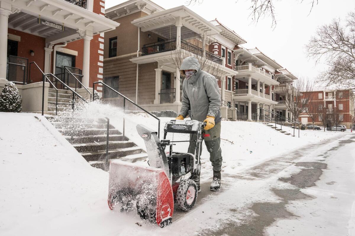 Preston Hawkins uses a snowblower to clear a path on Armour Boulevard in Kansas City on Tuesday, Feb. 18, 2025. Temperatures are expected to get barely above zero with dangerous wind chills through Wednesday.