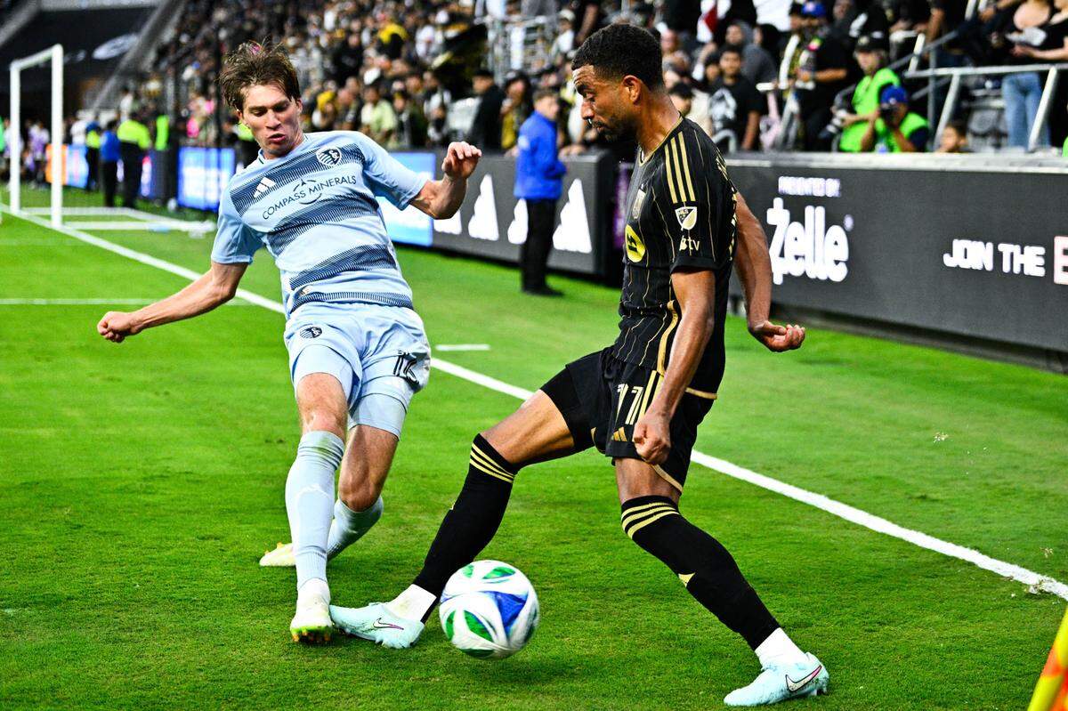 Sporting Kansas City defender Jacob Bartlett (16) kicks the ball out of bounds against LAFC midfielder Timothy Tillman (11) during the second half at BMO Stadium on June 8, 2025.