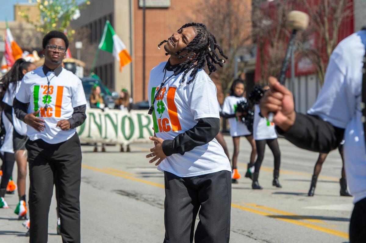A member from the KC Marching Falcons performs a dance during the Kansas City St. Patrick’s Day parade on Friday, March 17, 2023, in Kansas City.