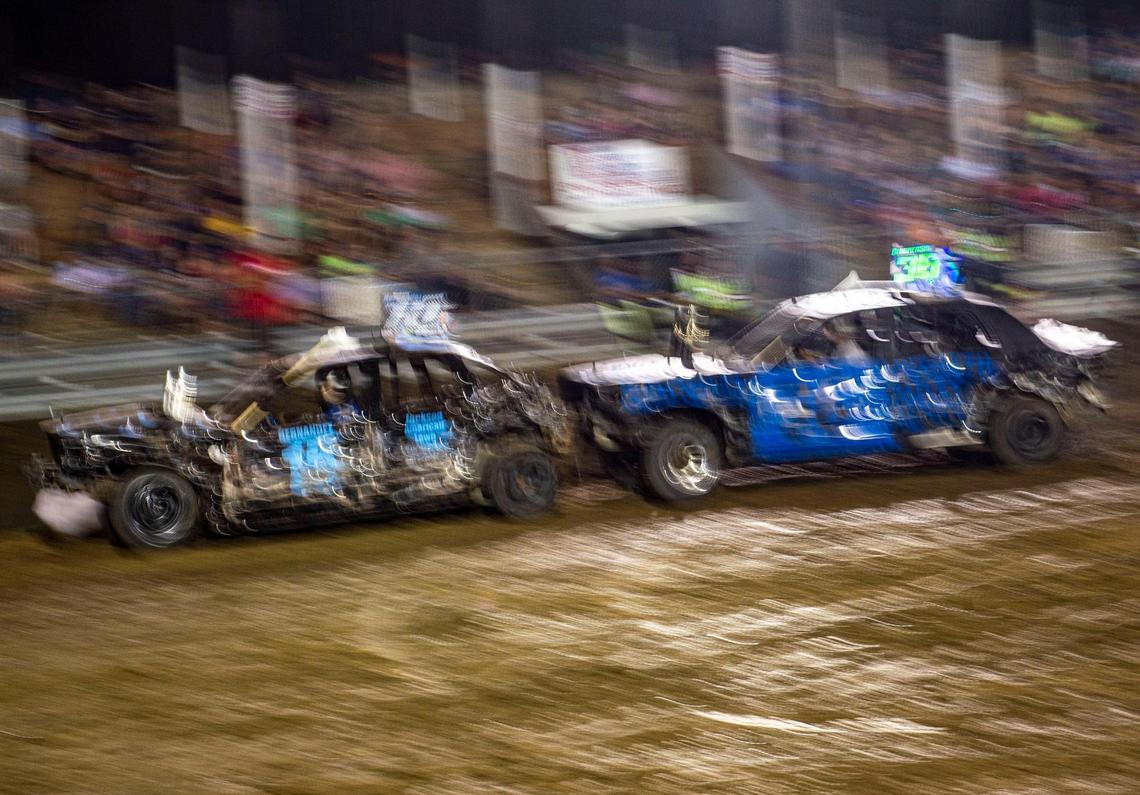 Drivers push each other in the final feature of the demolition derby at the Platte County Fair, Thursday, July 22, 2021, in Tracy, Missouri.