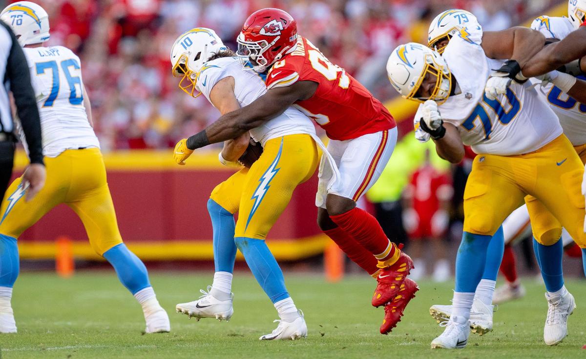 Kansas City Chiefs defensive end Charles Omenihu (90) sacks Los Angeles Chargers quarterback Justin Herbert (10) during an NFL football game at GEHA Field at Arrowhead Stadium on Sunday, Oct. 22, 2023, in Kansas City.
