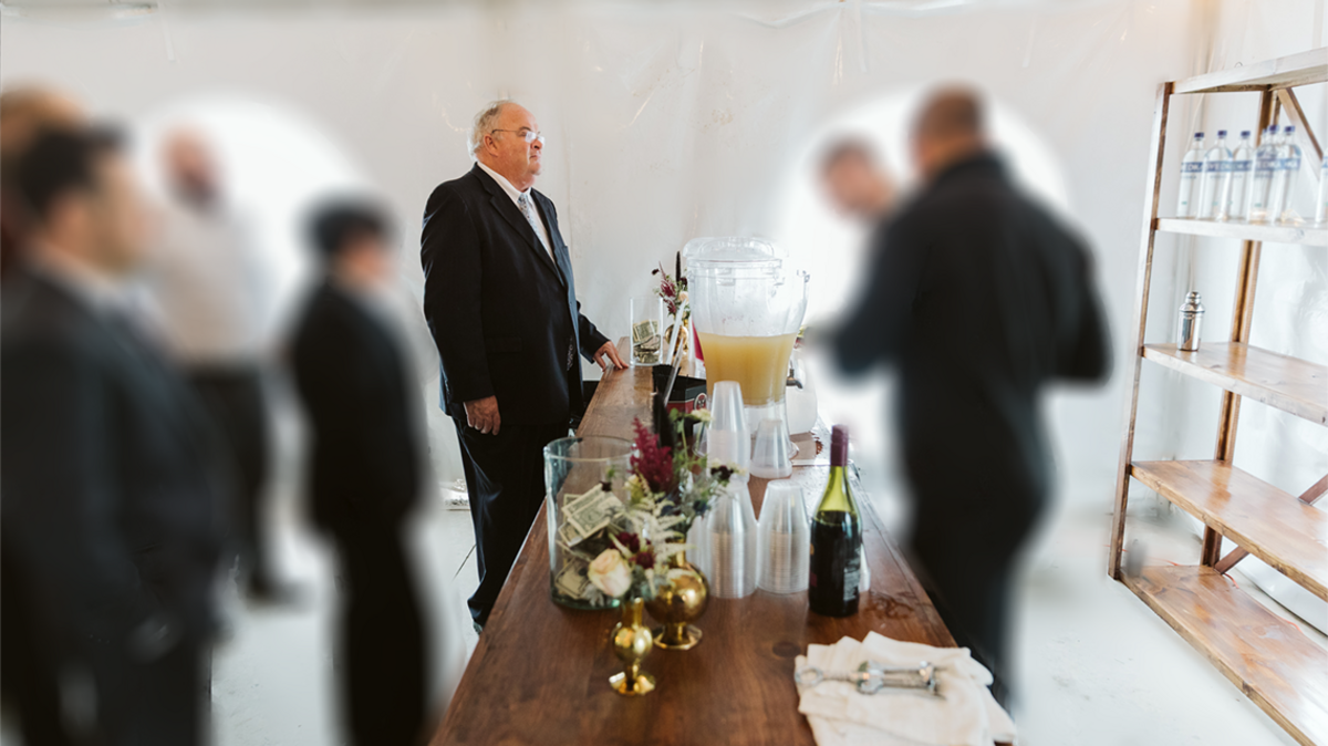 The “pro-Trump” GOP Senate candidate refused to be photographed with the couple he was supposedly friends with. And then he asked to come to the wedding.