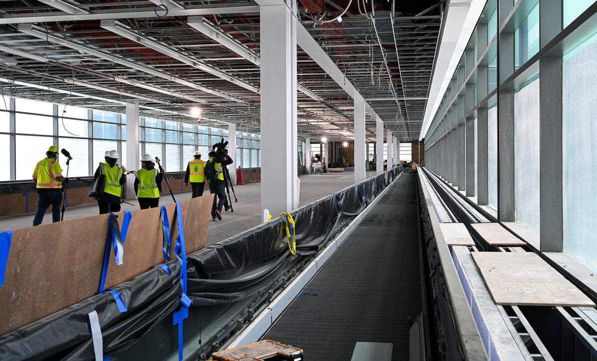 There will be four people movers in the 635-foot glass concourse connector that runs between the two sections of the new single terminal at Kansas City International Airport. The Kansas City Aviation Department gave a tour of the new terminal building to show its progress Thursday, March 24, 2022.