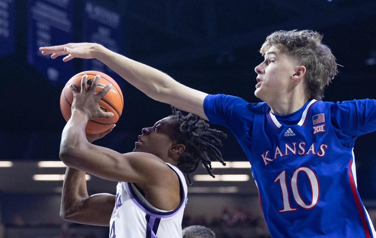 Kansas State’s Dai Dai Ames tries to get a shot off against Kansas defender Johnny Furphy during the second half of their game in Manhattan on Monday night.