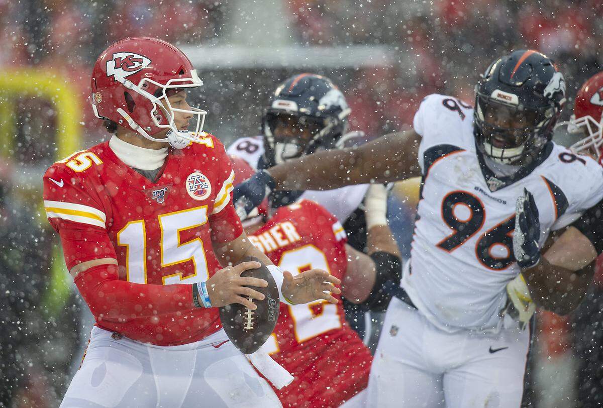 Kansas City Chiefs quarterback Patrick Mahomes looked for a receiver while under pressure from Denver Broncos defensive tackle Shelby Harris in the second quarter Sunday, December 15, 2019 at Arrowhead Stadium in Kansas City, Missouri.
