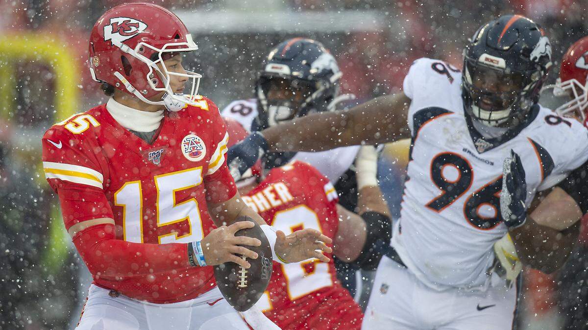 Kansas City Chiefs quarterback Patrick Mahomes looked for a receiver while under pressure from Denver Broncos defensive tackle Shelby Harris in the second quarter Sunday, December 15, 2019 at Arrowhead Stadium in Kansas City, Missouri.