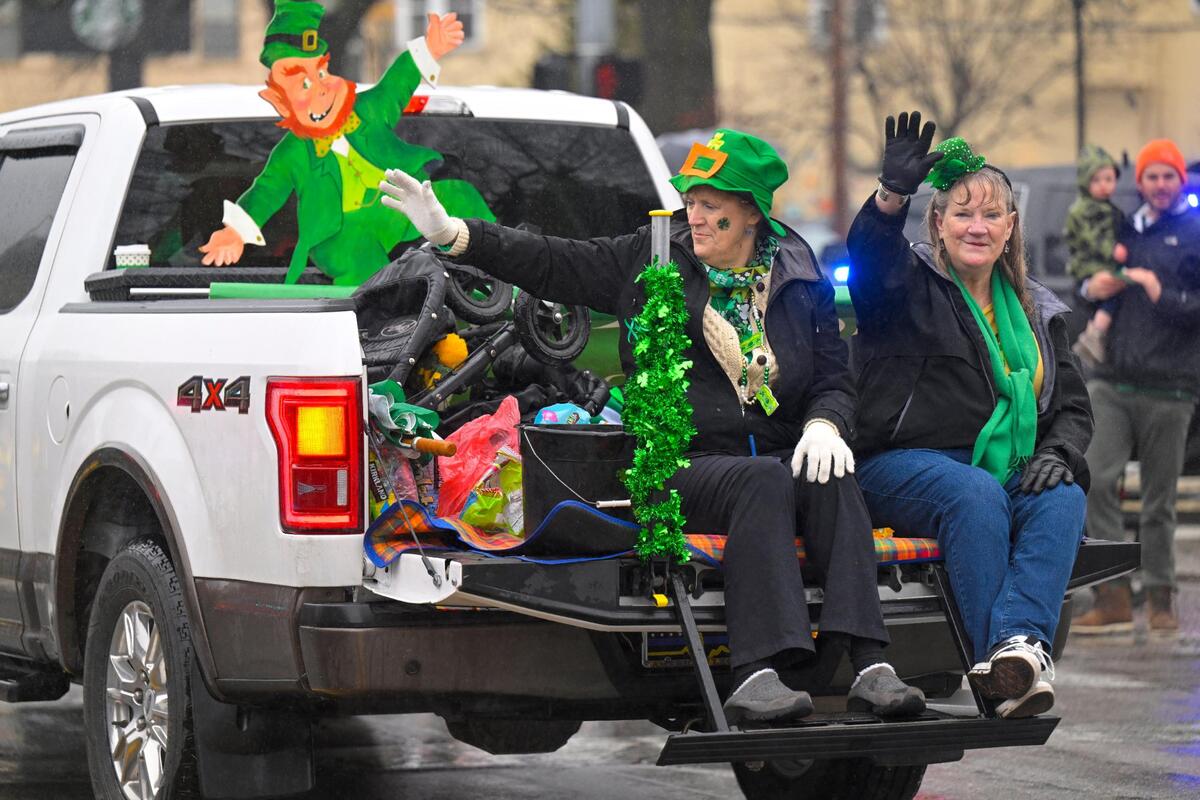 Members of the Flemington Clan waved to the crowd during the 2023 Brookside St. Patrick’s Day Warm-Up Parade on Saturday March 11, 2023 in Kansas City.