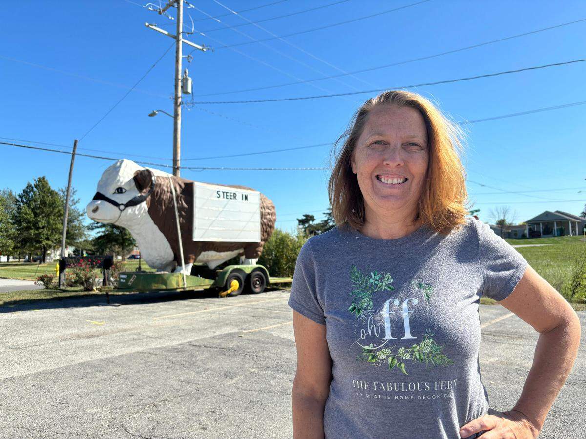 Rebecca Shipley poses for a portrait Oct. 7 with Sir Loin, a 12-foot-tall steer that advertises Shipley’s store, The Fabulous Fern. Shipley is selling Loin for $16,000 on Facebook Marketplace.