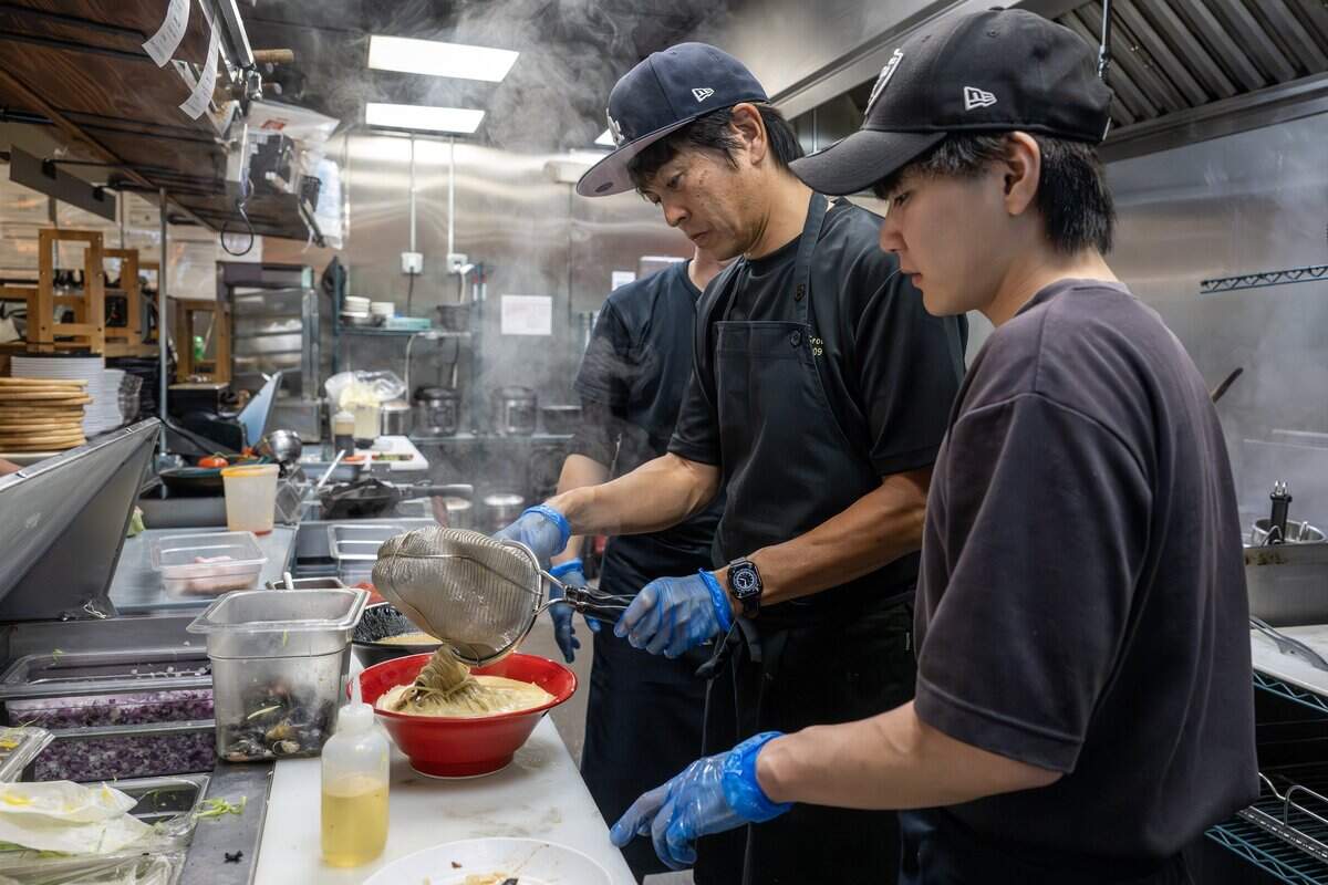Hattori Tatsuya, center, chef for Sugure in Japan, pours ramen noodles into a bowl at KC Craft Ramen on Tuesday, Aug. 19, 2025, in Overland Park. Sugure is part of a special pop-up hosted by Japanese nonprofit founder Madoka Koguchi.