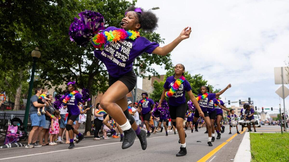 Member of the Kansas City Sizzlers Drill Team and Drumline dances down the street during the Kansas City's Annual Pride Parade at Westport Rd on Saturday, June 6, 2026.