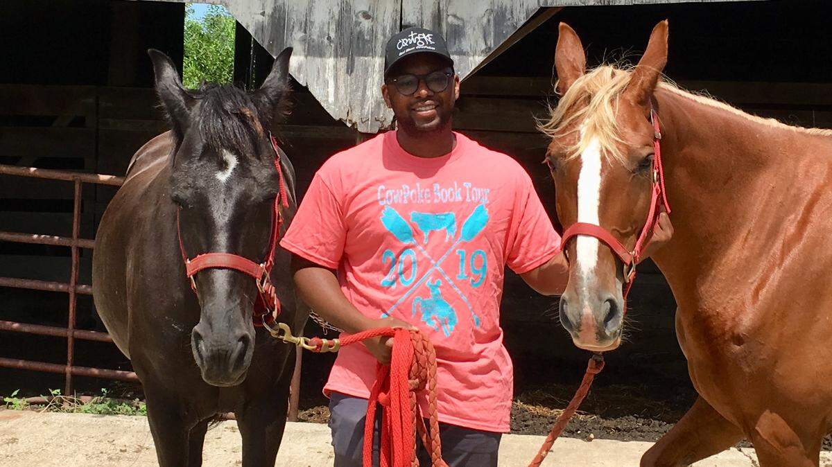 Trae Venerable cares for two of his family’s Tennessee Walking Horses in Spring Hill. Night Angel is on his left and Pretty Woman, on his right. Venerable, an Olathe author, has written children’s books about black cowboys who tended to cattle and horses in the Old West.