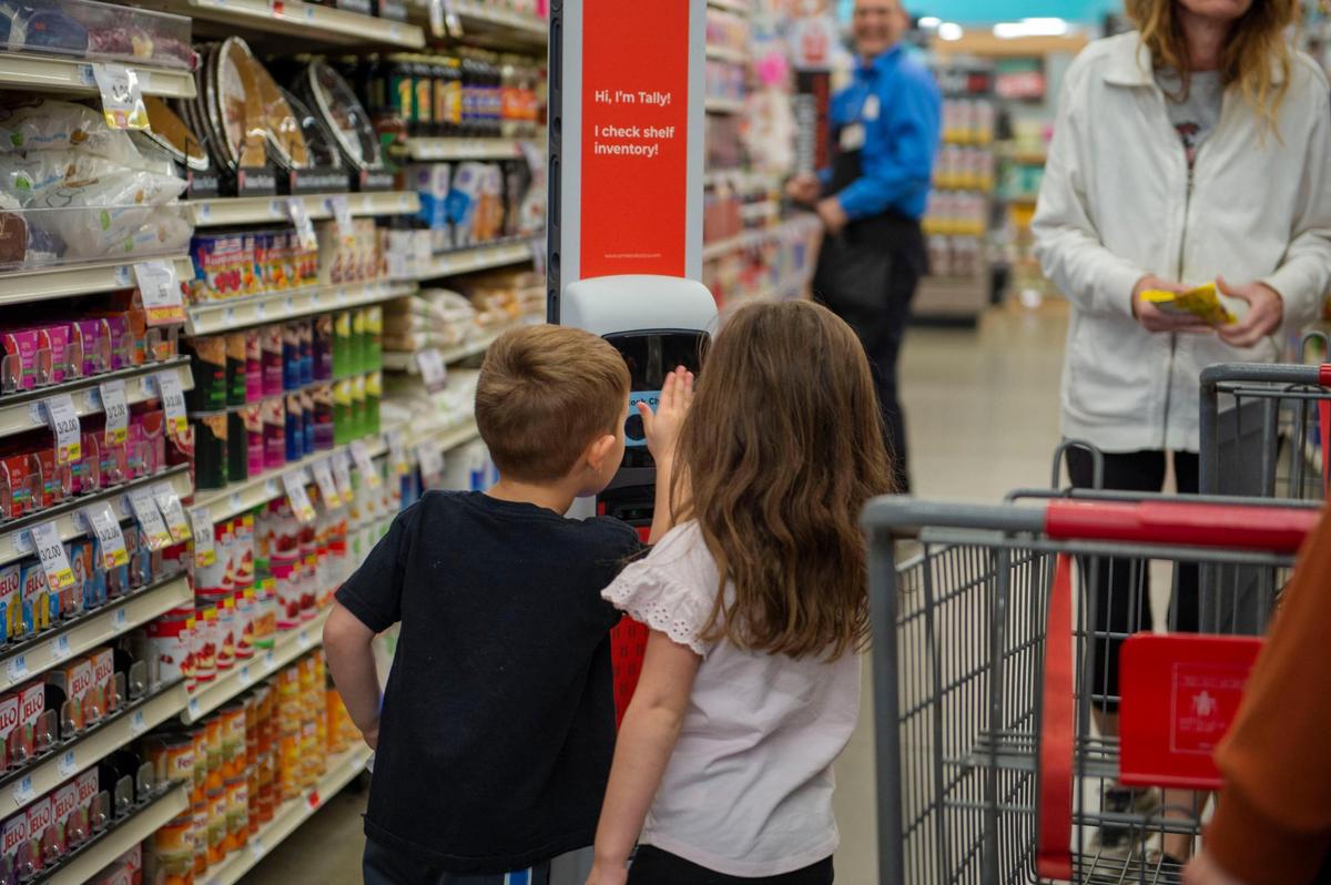 Luca Nigro, 3, and his 5-year-old sister, Gracie, inspect the inventory robot while their mother, Jessica Nigro, shops at Hy-Vee in Lee’s Summit.