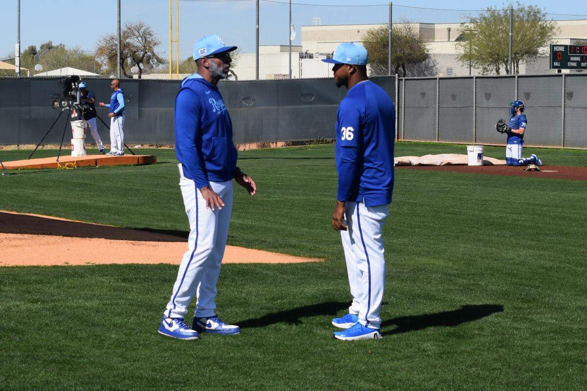 Former Kansas City Royals pitcher Edinson Vólquez chats with infield coach Jose Alguacil during the club’s workout on Feb. 24, 2025 in Surprise, Arizona.