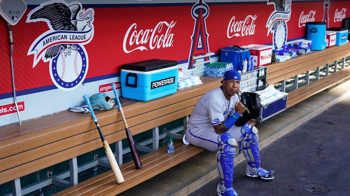Kansas City Royals catcher Salvador Perez (13) sits in the dugout before a baseball game against the Los Angeles Angels in Anaheim, Calif., Tuesday, June 21, 2022. (AP Photo/Ashley Landis)