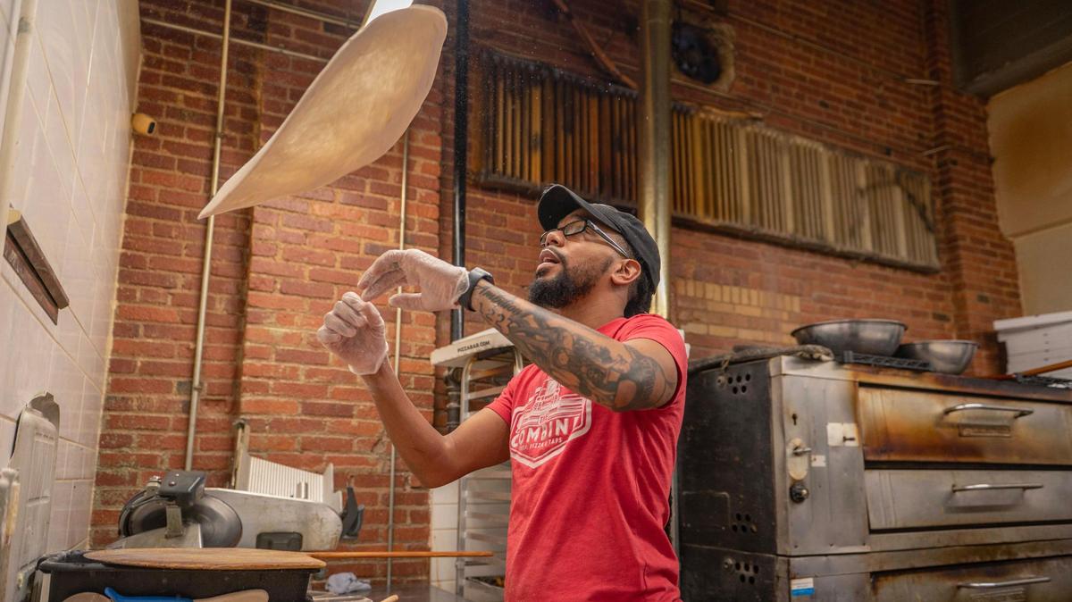“We wanted to become that local pizza hub for the community where you can watch the game and grab a beer,” says Alan Kneeland, co-owner of The Combine, seen here making one of his restaurant’s signature pizzas.