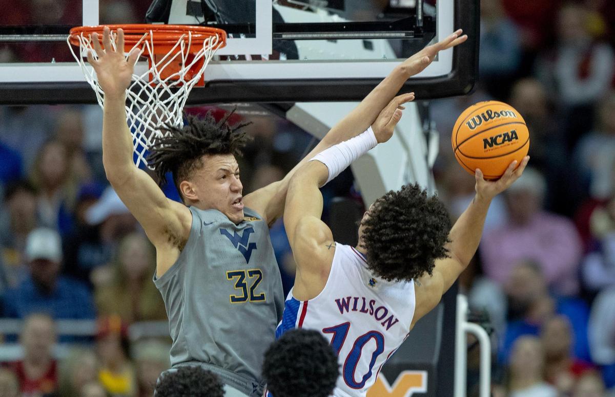 West Virginia forward James Okonkwo (32) contests a shot by Kansas forward Jalen Wilson (10) during an NCAA college basketball game in the second round of the Big 12 Conference tournament Thursday, March 9, 2023, in Kansas City.