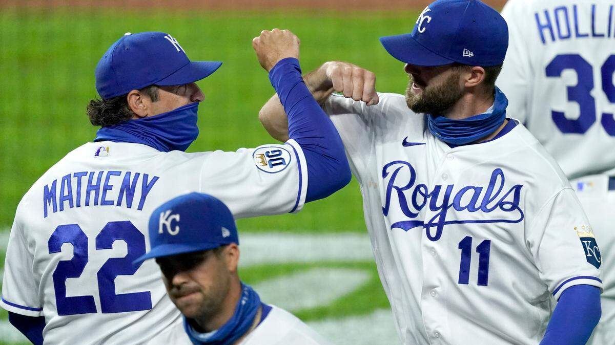 Kansas City Royals manager Mike Matheny (22) and Bubba Starling (11) celebrate after a baseball game against the Cleveland Indians, Monday, Aug. 31, 2020, in Kansas City, Mo. (AP Photo/Charlie Riedel)