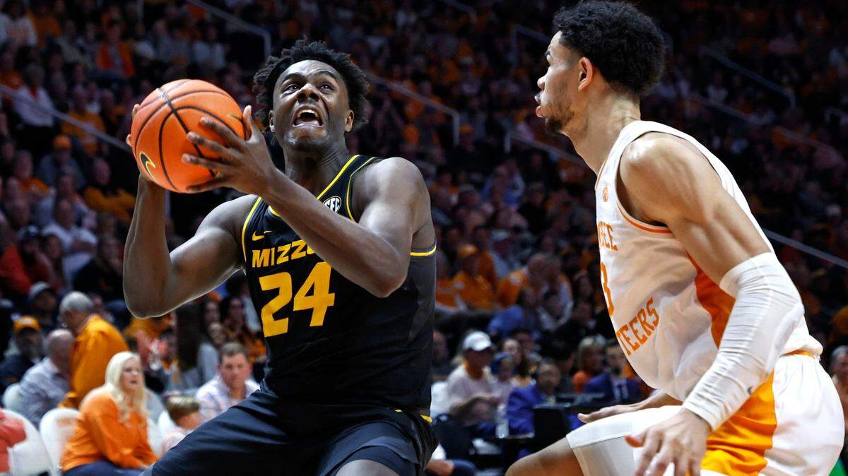 Missouri guard Kobe Brown drives for a shot against Tennessee forward Olivier Nkamhoua during the second half of the Tigers’ upset win on Feb. 11, 2023, in Knoxville, Tenn.