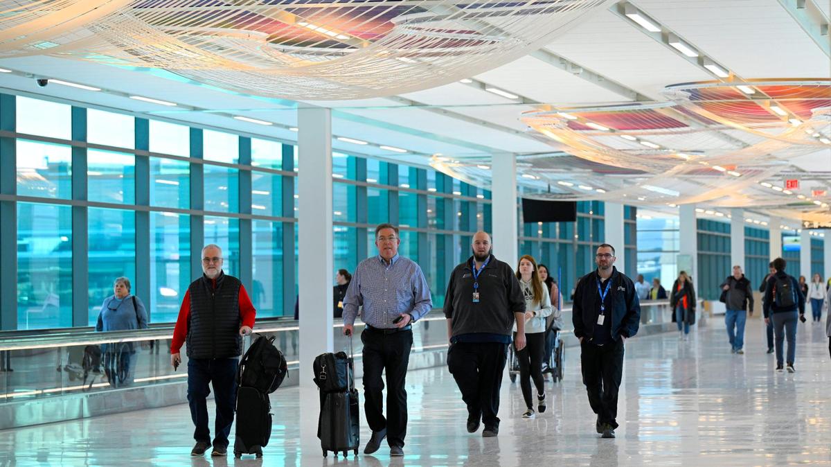 After going through security, travelers heading to the gates in the new $1.5 billion single terminal at Kansas City International Airport on opening day Tuesday, Feb. 28, 2023.