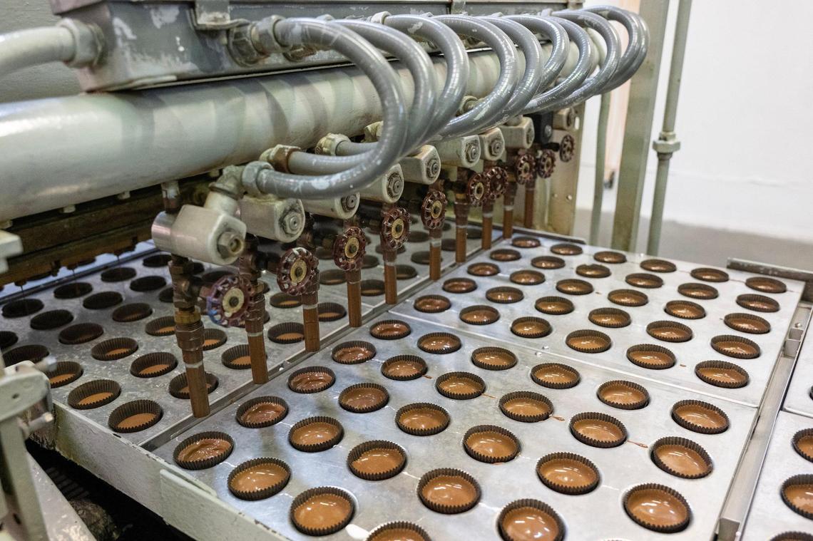 A quick burst of air forms the distinctive chocolate cups for Sifers Valomilk’s signature marshmallow-filled chocolate cups.