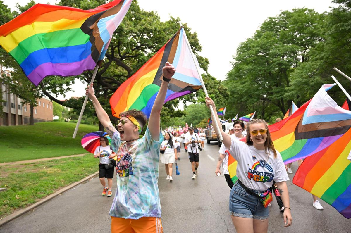 Maddie Anderson, left, and Jessi Carpenter celebrated during the KC Pride Parade as they marched with a group from SportingKC on Saturday in Kansas City. Floats, performers and community groups participated in this year’s parade, which celebrated the LGBTQ+ community.