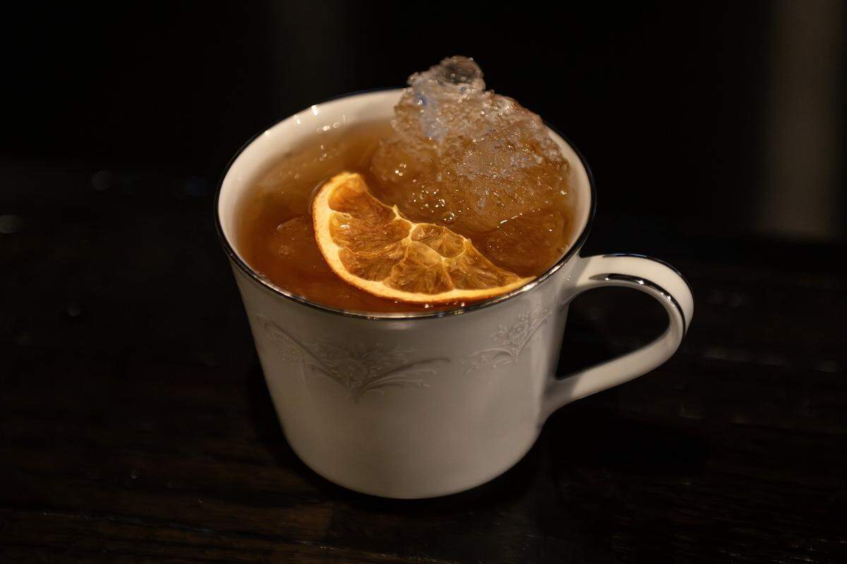 The Old Sprt cocktail is served at The Blacklist on Tuesday, Jan. 20, 2026, in Leawood. The drink combines bourbon, rum, Benedictine, coconut sugar, vanilla, and coffee reduction, finished with an orange slice.