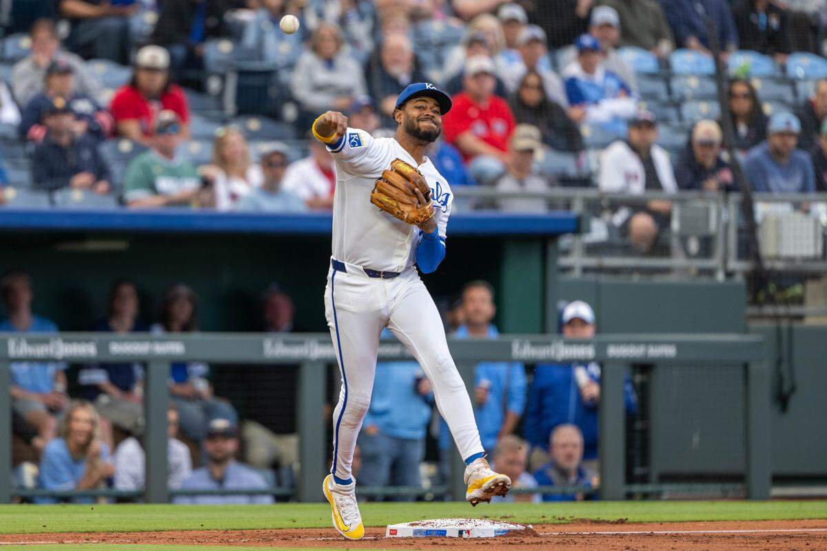 Kansas City Royals third baseman Maikel Garcia throws the ball to first base to complete a double play against the Boston Red Sox on Wednesday, May 20, 2026, at Kauffman Stadium.