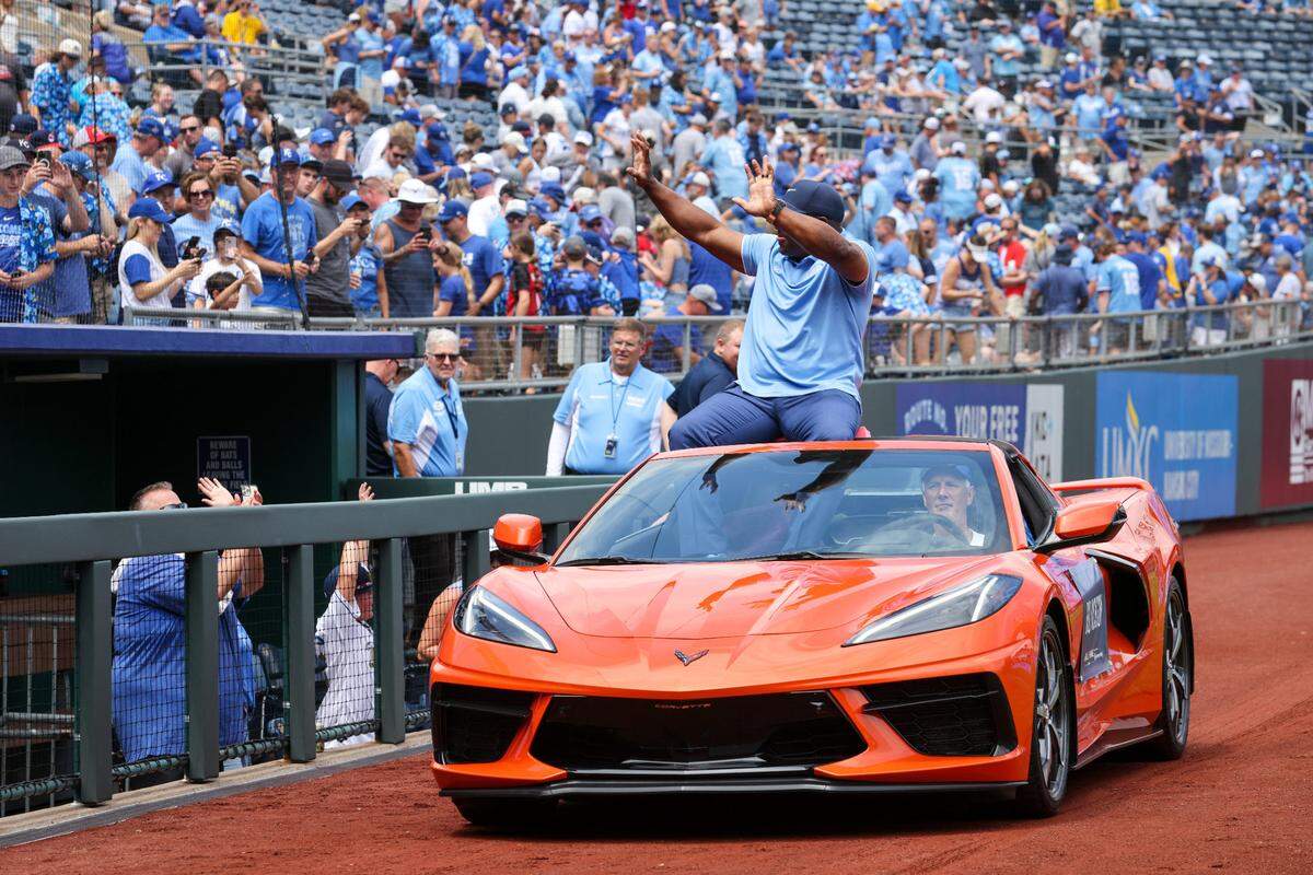 Bo Jackson waves to fans from an orange Corvette as he enters Kauffman Stadium for his Royals Hall of Fame induction ceremony on Saturday in Kansas City.
