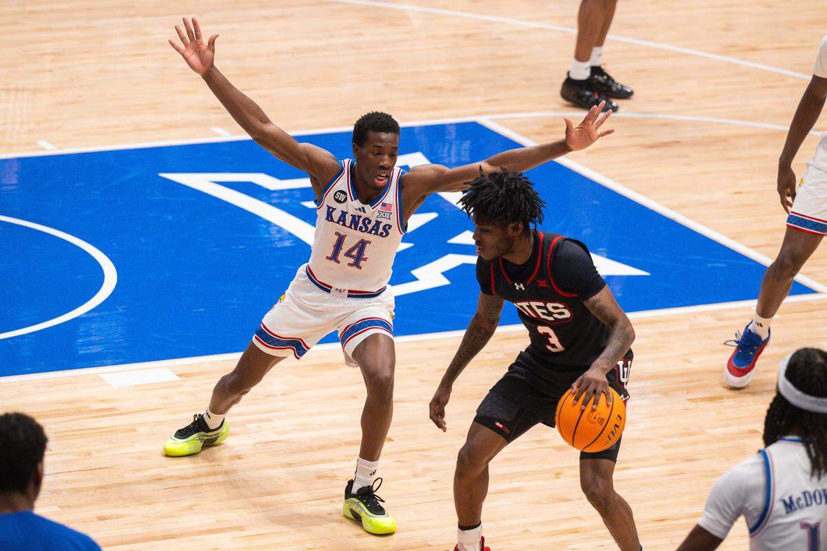 Kansas Jayhawks guard Melvin Council Jr. (14) defends Utah Utes guard Don McHenry (3) in the first half on Saturday, February 7, 2026, at Allen Fieldhouse.