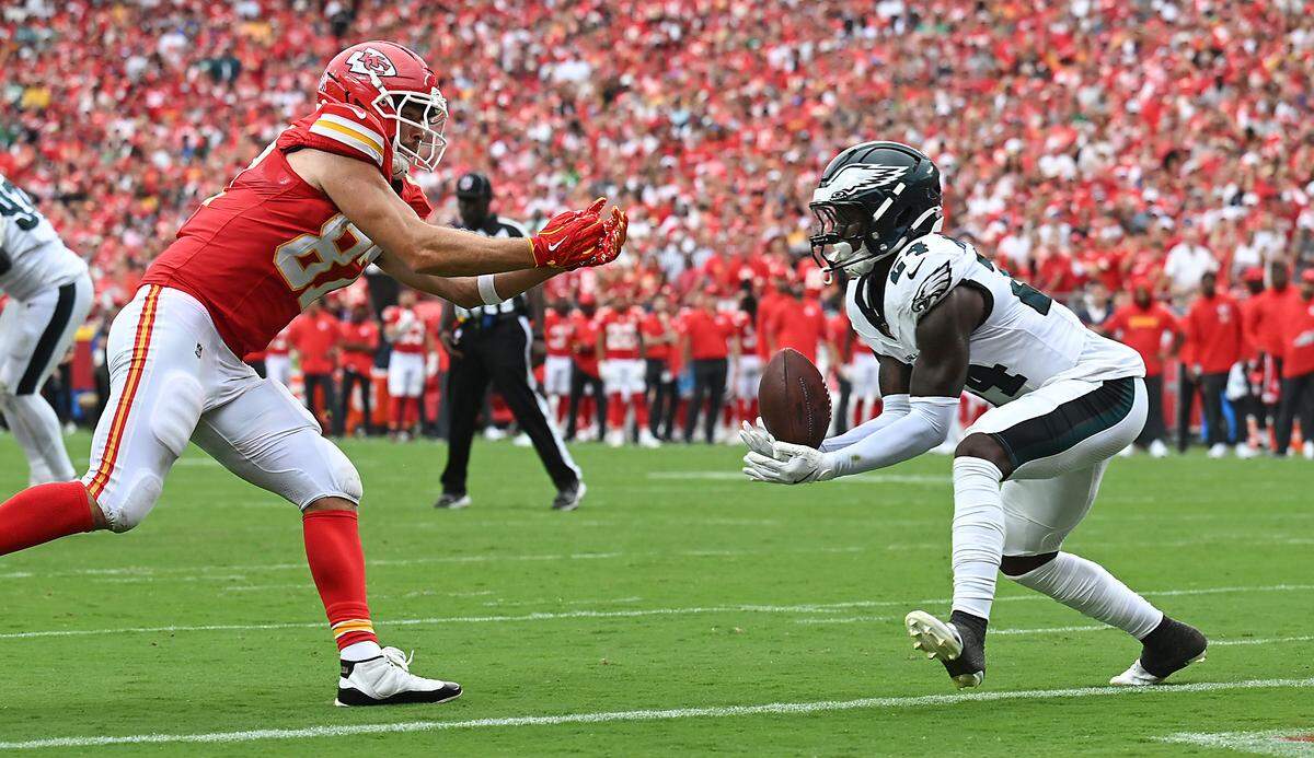 Philadelphia Eagles safety Andrew Mukuba (24) intercepts a pass near the Chiefs' goal line after it bounced off of Kansas City Chiefs tight end Travis Kelce (87) in the fourth quarter on Sunday, Sept. 14, 2025, at GEHA Field at Arrowhead Stadium.