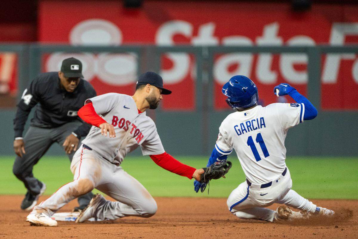 Kansas City Royals third baseman Maikel Garcia, right, is tagged out by Boston Red Sox second baseman Isiah Kiner-Falefa during KC’s loss on Tuesday, May 19, 2026, at Kauffman Stadium.