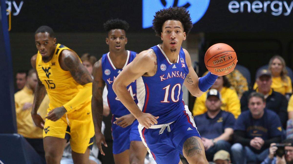 Kansas forward Jalen Wilson, right, runs up the court against West Virginia during Saturday’s Big 12 game in Morgantown, W.Va.