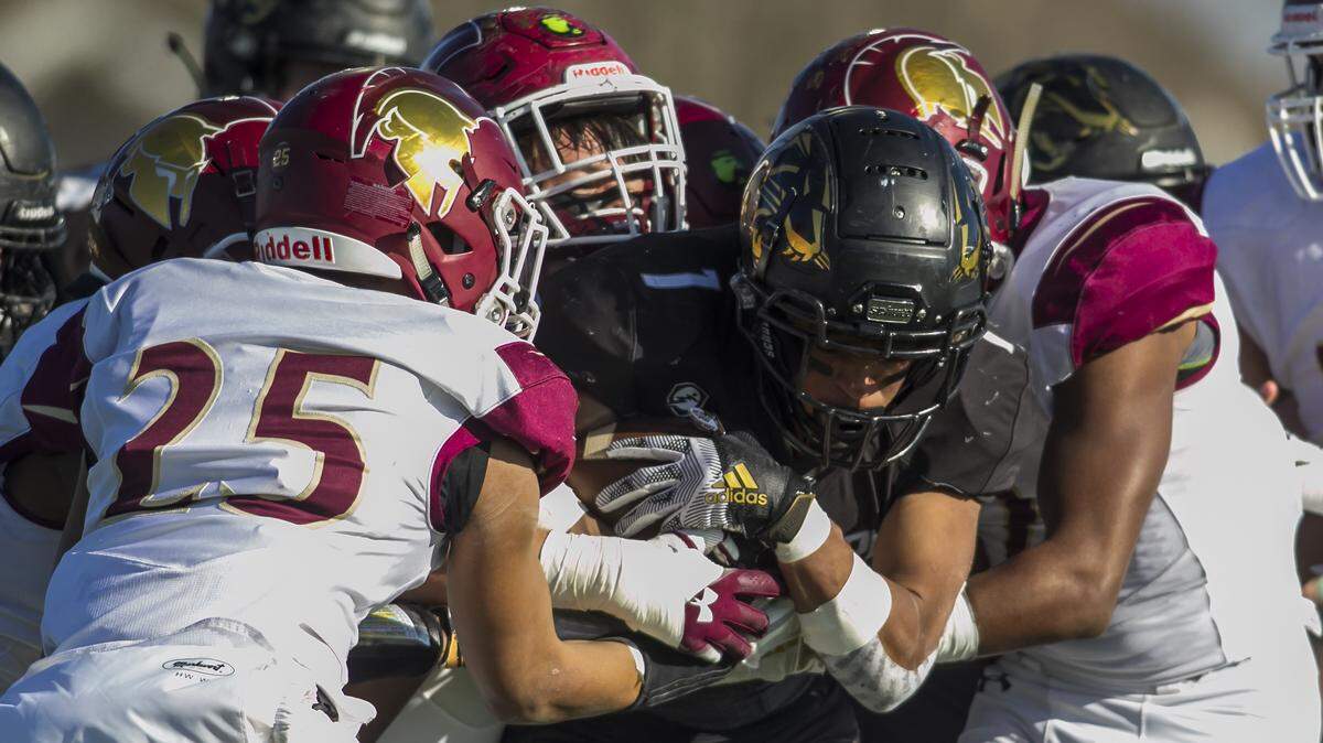 Senior Ray-Pec running back Gabe Shanklin (1) is stopped by a host of De Smet defenders during the game between the Ray-Pec Panthers and the DeSmet Spartans on Saturday November 21, 2019 at Ray-Pec High School in Raymor, MO. Nick Tre. Smith/Special to the Star