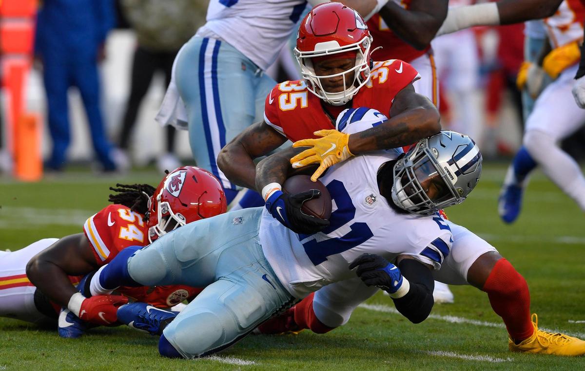 Dallas Cowboys running back Ezekiel Elliott is brought down by Kansas City Chiefs defenders Nick Bolton, left, and Charvarius Ward during the first quarter of Sunday’s NFL game at Arrowhead Stadium. Kansas City beat Dallas, 19-9.