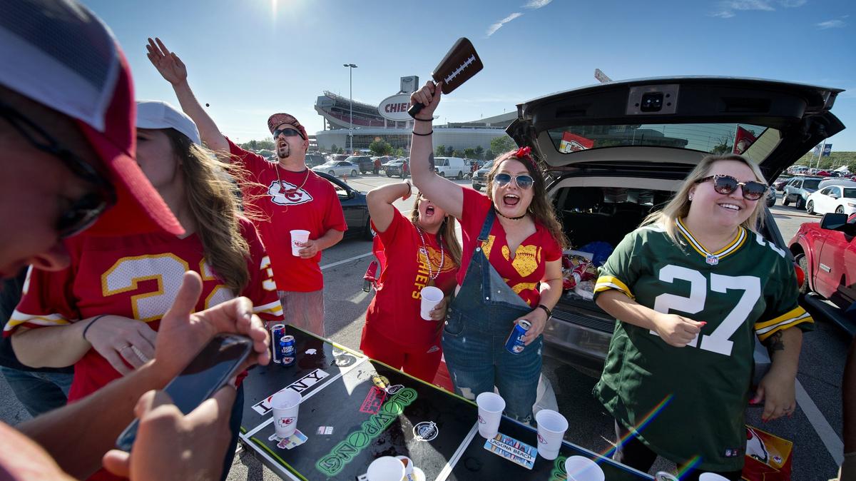 Tailgaters Joe Bailey (from left facing camera), Sarha Draves and Becca Boo, all from Kansas City, Kan., and neighboring tailgater Jessica Verwers (right) of Des Moines partied before the Chiefs’ final preseason game against the Green Bay Packers last summer.