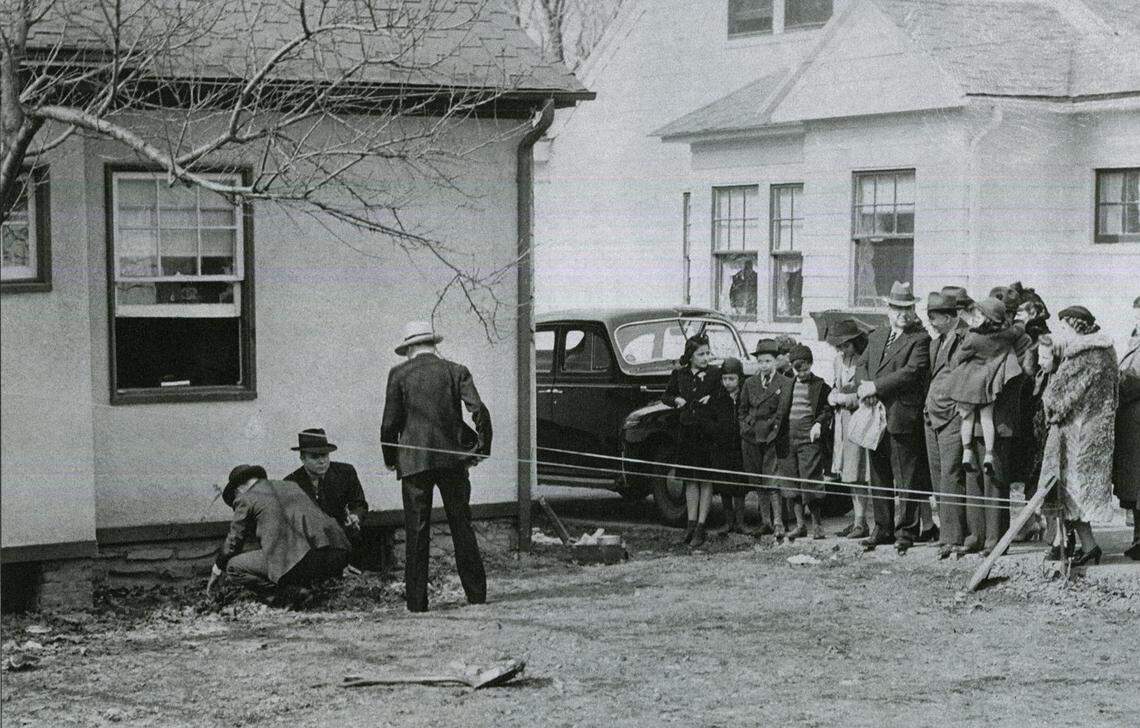 Police investigate the backyard below Leila Welsh’s window while curious neighbors look on.