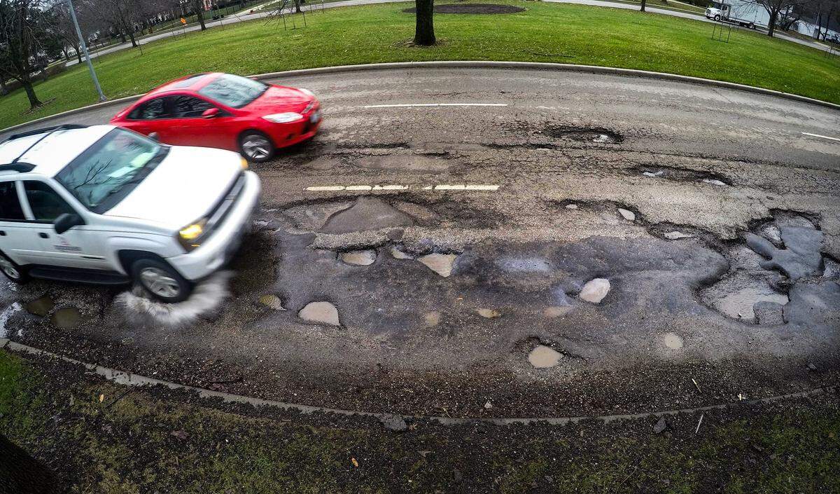 Cars driving along Kansas City area streets have been faced with minefields of potholes left from a long winter of freeze and thaw cycles. These potholes located along Ward Parkway were filled with asphalt as a temporary fix shortly after they were photographed on Friday, March 29, 2019.