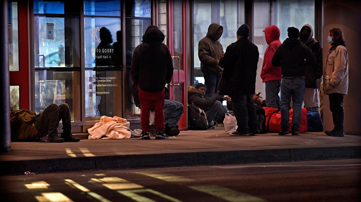 Kansas City has opened Bartle Hall as a warming shelter for people without homes for the rest of this winter, city officials announced on last Friday. One of the largest exhibit spaces in the downtown Kansas City Convention Center is now equipped with cots and other services. The announcement came as the city’s existing warming shelter struggled to meet demand because the COVID-19 pandemic and ensuing economic fallout that has led to so many people losing their homes. Several of the homeless gathered there on a recent evening waiting for the shelter to open.