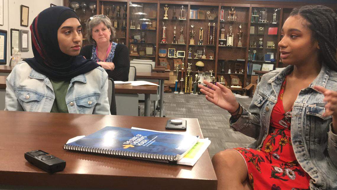 Lincoln College Preparatory Academy students Nadeen Alsalman, left, and Assata Jihad discuss mental health issues at their school while Linda Bishop, the faculty adviser for the school’s Future Medical Professionals club, listens.