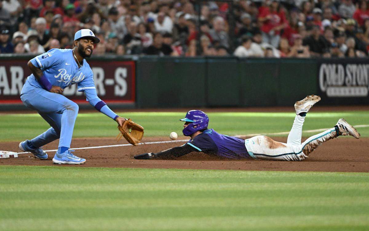 Blaze Alexander #9 of the Arizona Diamondbacks slide safely into third base as Maikel Garcia #11 of the Kansas City Royals waits on the ball during the eighth inning at Chase Field on July 5, 2025 in Phoenix.