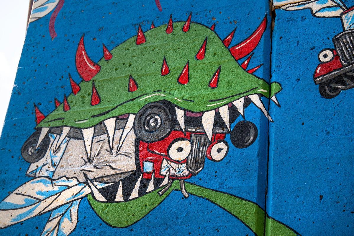 A detail of the “Venus Fly Truck” shows one of the giant plants eating an insect-like truck.