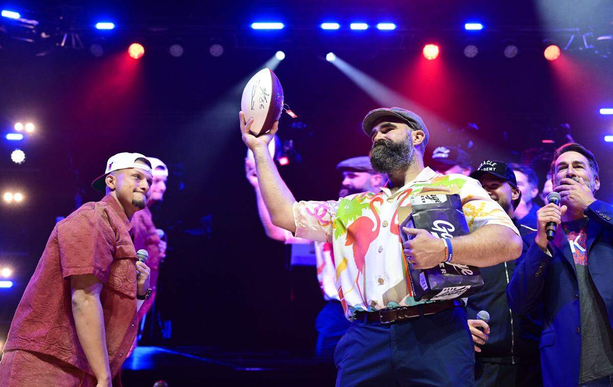 Jason Kelce, with football, and Patrick Mahomes were on the stage Saturday, May 31, 2025, during the Big Slick Party and Show at T-Mobile Center in Kansas City.