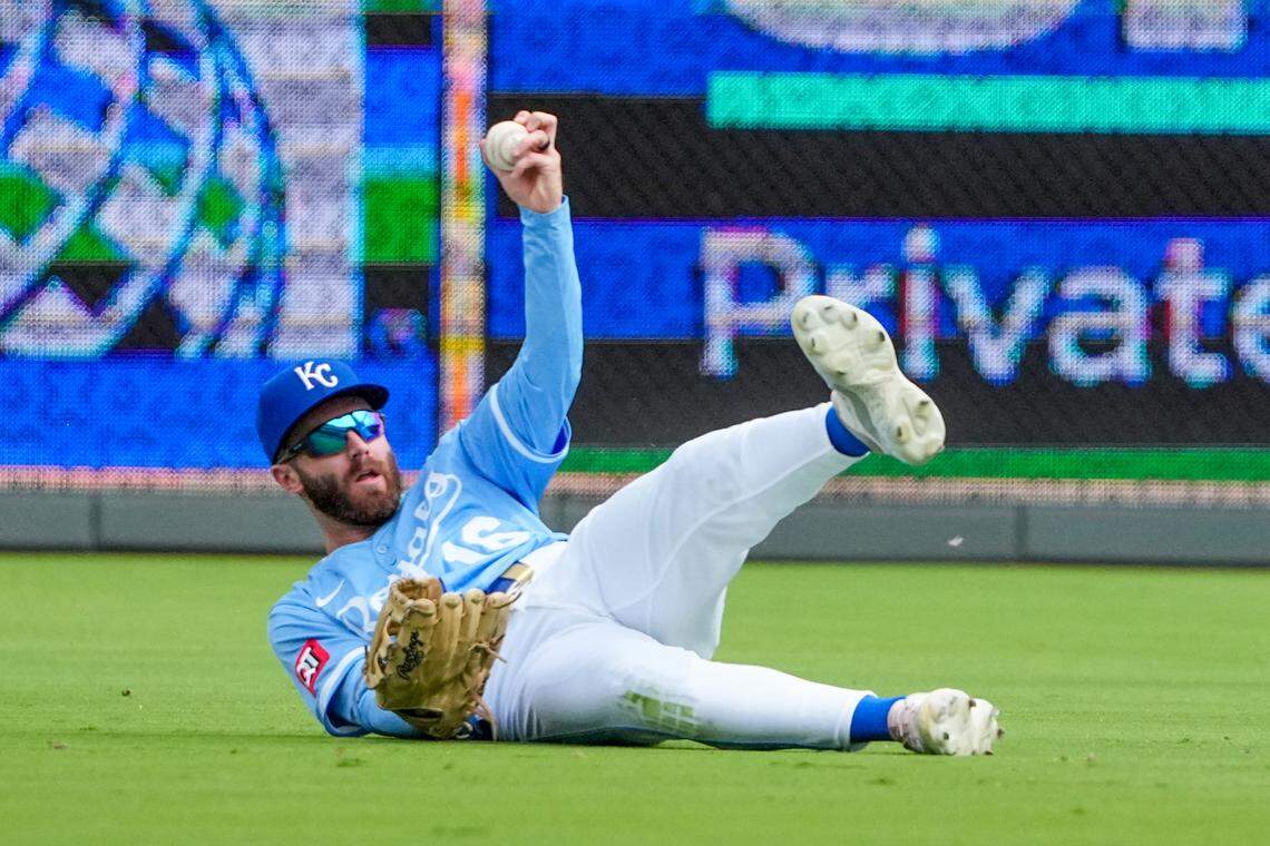Royals center fielder John Rave holds up the ball after making a sliding third-inning catch against the Toronto Blue Jays during a Major League Baseball game at Kauffman Stadium in Kansas City on Sunday, Sept. 21, 2025.